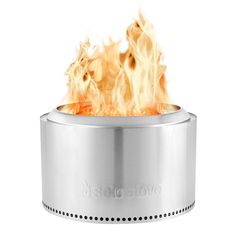 a stainless steel stove with flames coming out of it's top and bottom lid