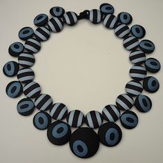 a necklace with black and white circles on it