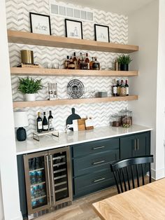 a kitchen with open shelving and wine bottles on the shelves