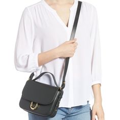 The Crossbody Bag Is Crafted From Italian Leather And Includes An Interior Pocket And A Card Slot. It Features An Optional Top Handle For Hand Carry And Is Perfectly Sized To Hold The Daily Essentials. - Top Handle - Detachable, Adjustable Shoulder Strap - Magnetic - Exterior Slip Pocket - Interior Zip Pocket - Approx. 8.5" W X 6.5" H X 2.5" D - Approx. 21-23" Strap Drop, 3" Handle Drop Chic Everyday Flap Bag With Branded Hardware, Workwear Shoulder Flap Bag With Branded Hardware, Gold-tone Hardware Crossbody Flap Bag For Work, Workwear Crossbody Flap Bag With Gold-tone Hardware, Chic Black Saddle Bag With Branded Hardware, Elegant Workwear Saddle Bag With Branded Hardware, Elegant Saddle Bag With Branded Hardware For Work, Elegant Saddle Bag For Work With Branded Hardware, Chic Satchel Saddle Bag For Work