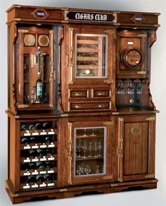 an old fashioned liquor cabinet with many bottles and glasses on it's doors open