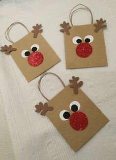 three brown paper bags with reindeer faces on them