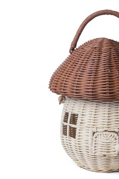 a brown and white basket with a house on it's top sitting in front of a white background