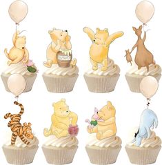 the cupcakes are decorated with winnie the pooh and other cartoon characters on them