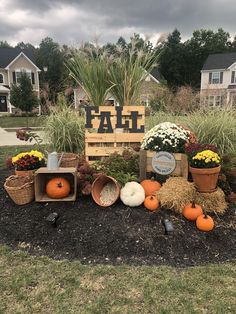 a sign that says fall with pumpkins, hay and flowers in front of it