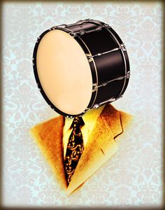 a man wearing a suit and tie with a drum on his head in front of him