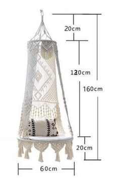 a white hanging hammock with tassels on the bottom and measurements for it