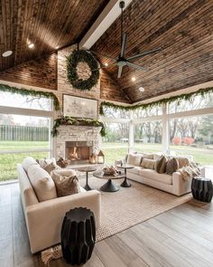 a living room filled with furniture and a fire place in the middle of an open floor plan