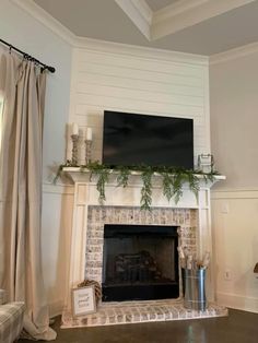 a living room with a fire place and a flat screen tv mounted above the fireplace