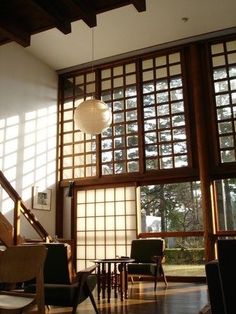 a living room filled with furniture and lots of windows