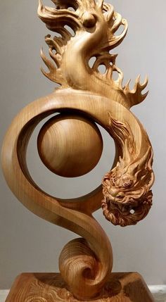 an intricate wooden sculpture is displayed on a table