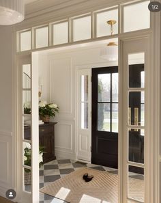 an open door leading into a room with black and white checkered flooring