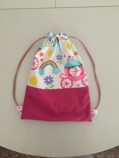 a drawstring bag sitting on top of a white table next to a wall