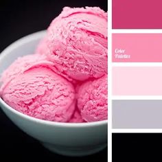 a bowl filled with pink ice cream on top of a black table next to a color swatch