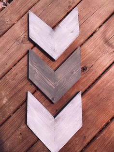 three pieces of wood sitting on top of a wooden floor