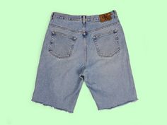 "Vintage 90's retro Calvin Klein Jeans denim shorts, they have been cropped. Zipper and button fly. Very good vintage condition, a couple of faded marks and over-all fade, perfect for a relaxed 90's look. They would fit waist 33\" - 34\". Size tag reads 34. Please read the measurements below very carefully and compare to one of your own garments, to avoid any disappointment regarding the fit. Item is measured flat: - waist: 42 cm; - front rise: 32 cm ; - length (waist to hem): 58 cm. All our ite 90s Style Cutoff Bottoms For Streetwear, Ck Jeans, 90s Looks, Jean Vintage, Trend Style, Short En Jean, Mens Denim Short, Calvin Klein Jeans, Denim Blue