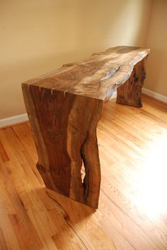 a wooden bench sitting on top of a hard wood floor