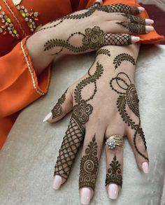 two hands with henna designs on them