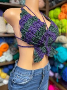 The purple and green are acrylic, soft yarn, and the rainbow is a soft cotton yarn both of these tops are the same size and can fit medium to large. You are getting one top for $35. Purple Crochet Tops For Beach, Purple Crochet Tops For The Beach, Purple Crochet Tops For Spring, Spring Purple Crochet Tops, Green Knitted Bohemian Tops, Casual Purple Crochet Top, Handmade Fitted Green Tops, Fitted Handmade Green Tops, Summer Purple Knitted Tops