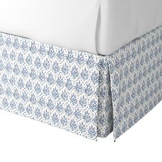 an image of a bed with blue and white sheets