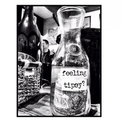 a bottle that has been labelled with the words feeling tippy on it, sitting on a table