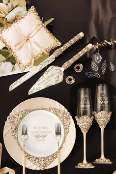 the table is set with champagne flutes, plates and napkins