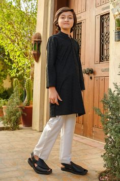 2 Piece Kurta Shalwar for Boys. Description: Top: Black Chikankari KurtaTrouser: White Cotton Trouser Country of Origin : Pakistan. General Care Instruction Should be washed in gentle cycle and hung to dry. Color may bleed so please be mindful of other items with it. General Disclaimer Size chart provides reference sizes and actual sizes might be slightly different from the size chart. Actual colors of the outfit may vary from the colors being displayed on the screen Black Cotton Sherwani For Festive Occasions, Festive Black Cotton Sherwani, Long Sleeve Cotton Sherwani With Dabka, Black Cotton Sherwani With Long Sleeves, Black Cotton Sherwani With Straight Kurta Shape, Black Cotton Sherwani Straight Kurta, Traditional Black Cotton Sherwani, Transitional Long Sleeve Cotton Sherwani, Black Naqshi Straight Kurta Traditional Wear