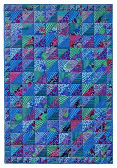 a blue quilt with many different colors and patterns on it, including pink, green, purple