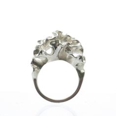 The top of this ring blooms into an intricately undulating surface, inspired by the frilly arms of a jellyfish. The ring is 3D printed in wax, then cast in silver using lost wax casting. Also available in brass, 14k gold, 18k gold, palladium, and platinum by special order.Our Florescence collection is inspired by the biomechanics of growing leaves and blooming flowers. Each piece emerges from a computational simulation of differential growth, a surface that grows at different rates in different