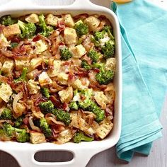 a casserole dish with bacon and broccoli in it on a table