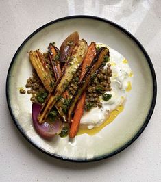 a white plate topped with carrots and beans