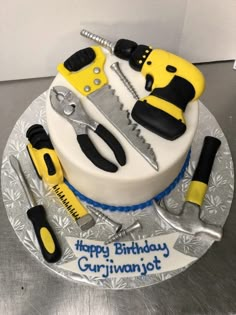 a birthday cake with tools on it and the words happy birthday gurivanot