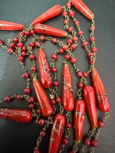 Vintage red glass ceramic beaded gilt metal chain link long end of day bead necklace 110cm Unique Red Jewelry With Beaded Chain, Unique Red Single Strand Jewelry, Red Long Necklace With Dangling Beads, Red Beaded Lariat Jewelry, Red Double Strand Beaded Chain Jewelry, Red Beaded Long Necklace As Gift, Red Beaded Long Necklace For Gift, Unique Red Beaded Chain Necklaces, Red Double Strand Beaded Jewelry