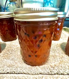 three jars with lids sitting on a table