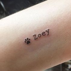 a person with a tattoo on their arm that says,'zoey'and has a dog paw