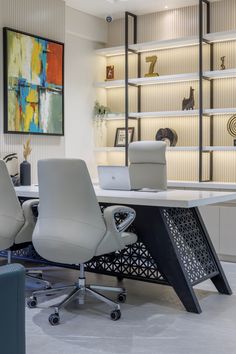 an office with two white chairs and a black table in front of a book shelf