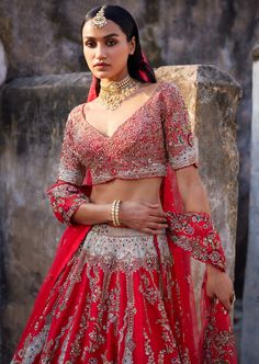 Red raw silk bridal lehenga with thread and zardosi embroidery with a tulle dupatta and a tulle head veil. Embroidered blouse. Red Raw Silk Dress With Sheer Dupatta, Hand Embellished Sharara For Traditional Ceremonies, Red Hand Embellished Choli, Hand Embellished Traditional Sharara For Ceremonies, Hand Embellished Red Choli, Red Raw Silk Set With Sheer Dupatta, Red Raw Silk Lehenga For Traditional Ceremonies, Red Raw Silk Saree For Wedding, Traditional Kundan Dress With Sheer Dupatta