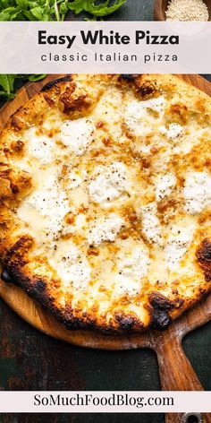 an easy white pizza on a wooden board with parmesan cheese and herbs in the background