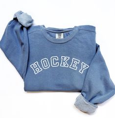 The perfect cozy sweatshirt for hockey games! Product Details: * Relaxed fit, medium-heavy fabric * 80% ring-spun cotton, 20% polyester * Color: Blue  * Unisex Fit; Please refer to the sizing chart in the listing photos to find your perfect fit! Care Details: * To maintain the quality of your sweatshirt, wash inside out on a delicate cycle and in cold water * Hang dry or lay flat to dry Shipping Details: * This product is made especially for you as soon as you place an order, which is why it takes a bit longer to deliver it to you.  * Please allow 1-2 weeks for processing, thank you! Winter Sports Fleece Sweatshirt, Fleece Sweatshirt For Winter Sports Events, Winter Fleece Sweatshirt For Sports Events, Winter Sweater With Ribbed Cuffs For Sports, Winter Sweater With Ribbed Cuffs, Winter Sports Event Sweatshirt With Ribbed Cuffs, Winter Crew Neck Sweats For Sports Events, Sports Fan Apparel Sweater With Crew Neck, Sporty French Terry Sweats With Letter Print