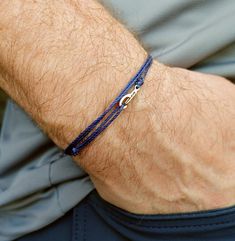 "A simple and minimalist waterproof navy blue string bracelet for men or women.  It wraps three times around the wrist or ankle and closes with a small metal hook. Cord - the cord is a high quality, long lasting waxed polyester cord that will hold up all well to  all your daily activities and to the elements.  You can wear this in the shower, to the office  and even when you are hiking, biking, surfing etc.  This cord wears very well and will remain a true blue color even with continuous wear. C Mens Minimalist Bracelet, Surf Bracelets, Guy Jewelry, Ocean Bracelet, Bracelets Men, Preppy Men, Surfer Bracelets, Bracelet Minimalist, Diy Bracelets Easy