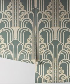 an art deco wallpaper design in grey and white with gold details on the walls