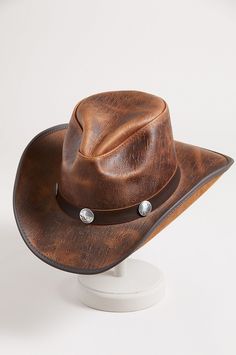 Honor your inner cowboy or cowgirl with the Renegade leather hat. From the handcrafted pinch crown to the 3" vinyl edged shapeable brim, this cowhide leather hat crowns you with good looking western flair. A matching hatband with buffalo conchos adds the perfect finish to a year round hat you can shape to your liking for just the right look, while the adjustable sweatband gives you a custom fit. Distressed Brown Adjustable Hat For Western-themed Events, Distressed Brown Short Brim Hat For Western-themed Events, Distressed Brown Hat With Short Brim For Western Events, Vintage Distressed Brown Hat For Rodeo, Leather Hats For Country Events In Distressed Brown, Distressed Brown Leather Hats For Country Events, Vintage Leather Fedora For Rodeo, Leather Fedora With Curved Brim For Country Events, Leather Distressed Brown Hats For Country Events