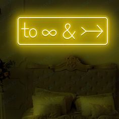 a neon sign above a bed in a room