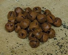 a pile of wooden bells sitting on top of a marble counter next to a knife