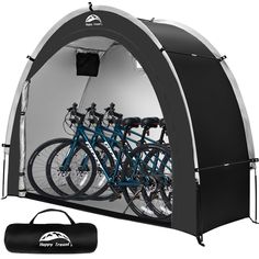 a group of bikes parked inside of a black and white tent with the words happy trails written on it