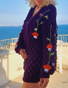 This knit cardigan is knitted with yarn in an elegant and eye-catching purple color. The entire cardigan is embroidered with quality handmade threads that are carefully selected and put together. This special cardigan features a strikingly embroidered mushroom pattern. Cork embroidery adds a natural charm and unique character to the cardigan. The embroidery is creatively shaped and knitted in detail. This craftsmanship makes the cardigan truly special and offers elegance and style to the wearer. Purple Bohemian Long Sleeve Sweater, Purple Long Sleeve Bohemian Sweater, Hand Knitted Long Sleeve Purple Sweater, Purple Knitted Long Sleeve Cardigan, Fall Crochet Purple Sweater, Purple Crochet Sweater For Fall, Handmade Purple Winter Cardigan, Winter Hand Knitted Purple Cardigan, Handmade Purple Winter Sweater