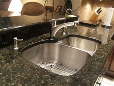 a kitchen with granite counter tops and stainless steel sink