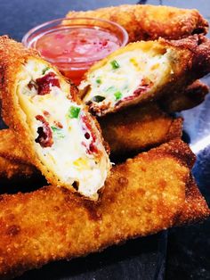 some fried food is on a plate with dipping sauce