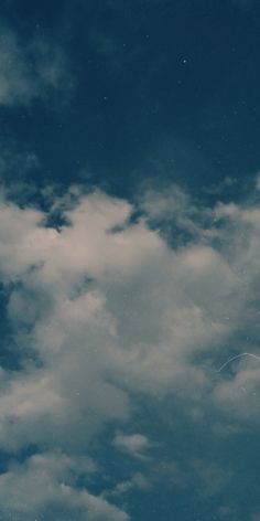 an airplane is flying in the sky with some clouds behind it and a jet trail