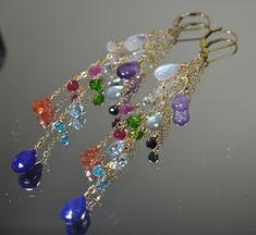 "These Earrings are a beautiful composition of Stunning Gemstones that are presented to You in a \"Rainbow\" of Colors: It will bring a smile to your recipient's face and it sure to go with any outfit! Each Earring features 14 Unique Gemstones in a variety of shapes and sizes. This gives the earrings lots of character and each gemstone is individually hand wired for a more bohemian look and feel. >Rainbow, Rainbow Statement Earrings, Chain Drop Earrings, Gemstone Earrings, Duster Earrings, Lo Elegant Multi-stone Drop Gemstones, Elegant Multi-stone Briolette Earrings, Elegant Multi-stone Drop Jewelry, Elegant Multicolor Drop Jewelry, Fine Jewelry Multi-stone Drop Earrings, Elegant Teardrop Multi-stone Jewelry, Elegant Multi-stone Gemstones In Sterling Silver, Elegant Multistone Sterling Silver Gemstones, Elegant Multi-stone Sterling Silver Gemstones